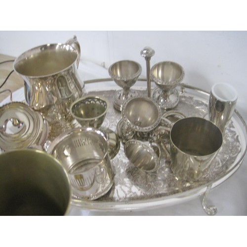 19 - An assortment of electroplated dining and table ware, including trays, goblets, egg cruets, cutlery,... 