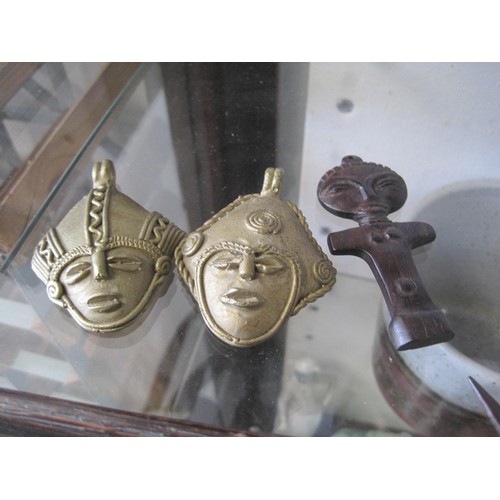 91 - An assortment of tribal items - a pair of small brass mask pendants (6.5cm x 5cm), a small hardwood ... 