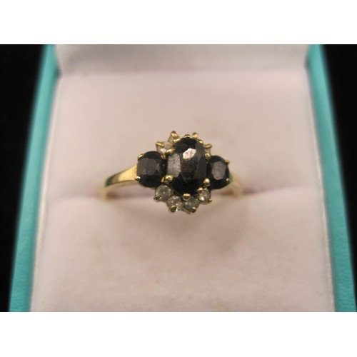 164 - Two 9 carat gold sapphire dress rings. (1) Ring set with an oval sapphire (about 7mm x 5mm) with two... 