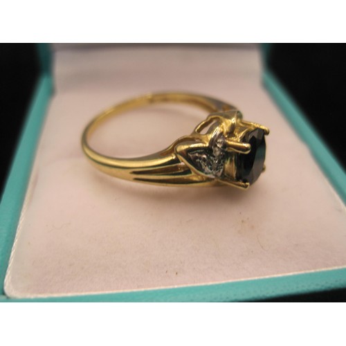 164 - Two 9 carat gold sapphire dress rings. (1) Ring set with an oval sapphire (about 7mm x 5mm) with two... 