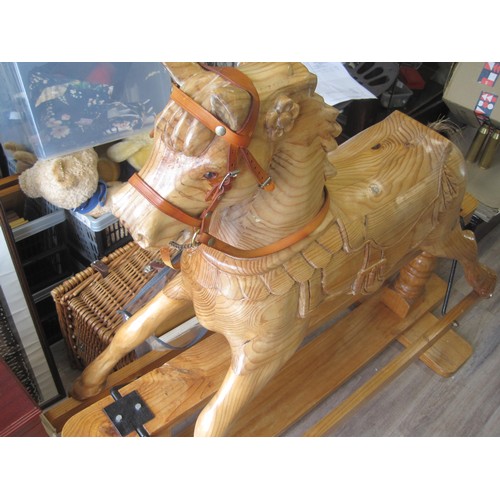 174 - An imposing, hand-carved rocking horse of solid wood with horsehair tail and cast-iron fittings on a... 