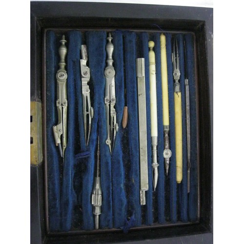 220 - An antique draughtsman's or drawing set, contained in a hardwood brass-bound case, two lift-out tray... 