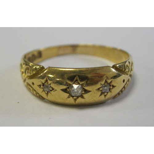 149 - 18 carat gold gypsy set diamond ring, three small round cut diamonds, scrolled chasing at the should... 