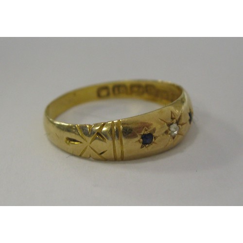 153 - A Victorian 18 carat gold ring with gypsy setting of a small diamond centrally, with a sapphire to e... 