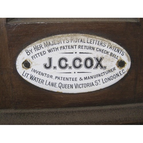 7 - An antique coin sorter on wooden stand with manufacturer's plate for J C Cox of Queen Victoria Stree... 