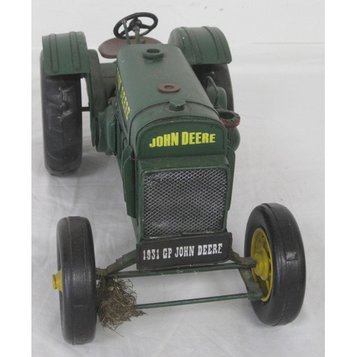 36 - A brass model of Stephenson's Rocket mounted on a wooden plinth and a tin plate model of a John Deer... 