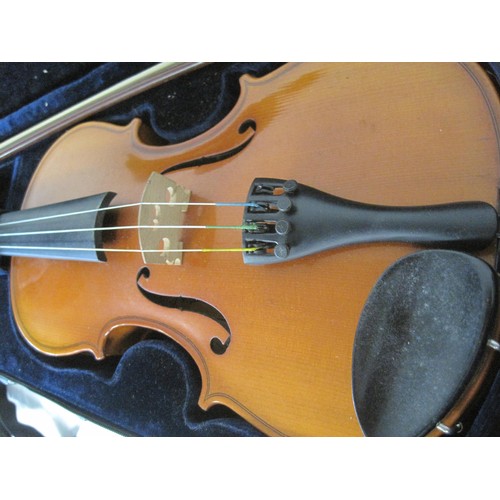 90 - A vintage cased violin, maker's name marked internally as Michael Poller, with bow.