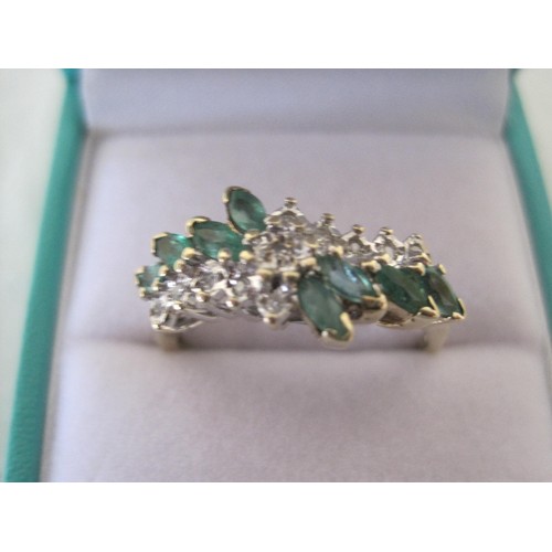 110 - 9 carat gold ring set with a spray of eight marquise emeralds and eleven small white stones, ring si... 