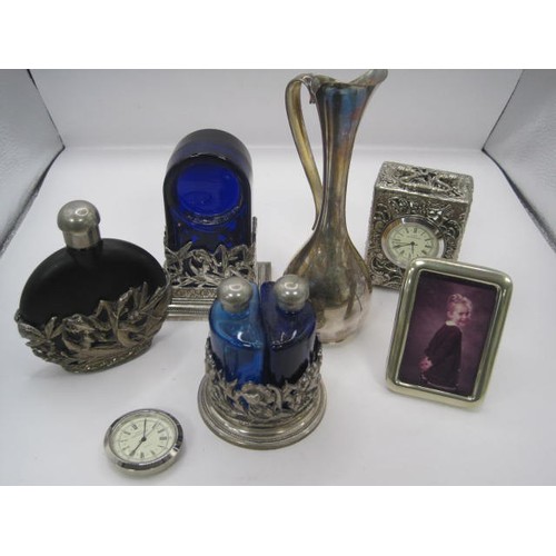 188 - A group of silver plated dressing table items including a scent bottle and two miniature clocks all ... 