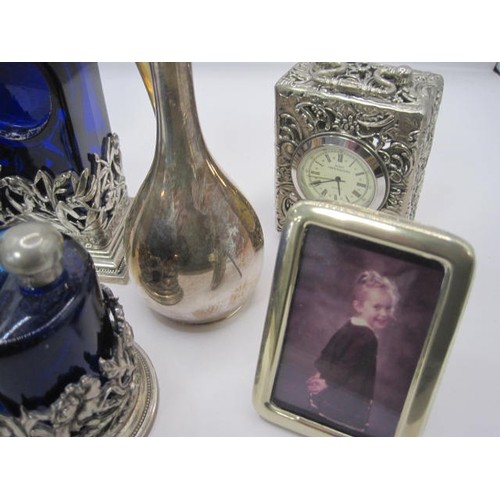 188 - A group of silver plated dressing table items including a scent bottle and two miniature clocks all ... 