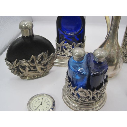 188 - A group of silver plated dressing table items including a scent bottle and two miniature clocks all ... 