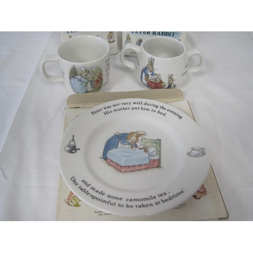 191 - Four items of Wedgwood Peter Rabbit and a Bunnykins money box. (1) Peter Rabbit two-handled mug, box... 