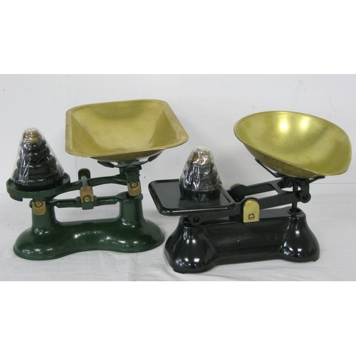 215 - Two vintage scales in iron with brass fittings and each with a set of weights, the pair in good orde... 