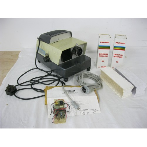 221 - A Paximat slide projector with four slide packs.
Generally in very good condition.