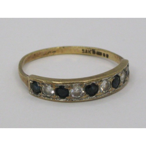 228 - A 9 carat gold eternity ring set with likely sapphires and zirconia, UK hallmarks, approx weight 1.4... 