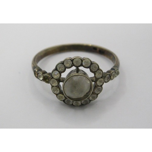 230 - A decorative daisy ring marked as 9 carat with centre clear stone surrounded by a ring of the same w... 