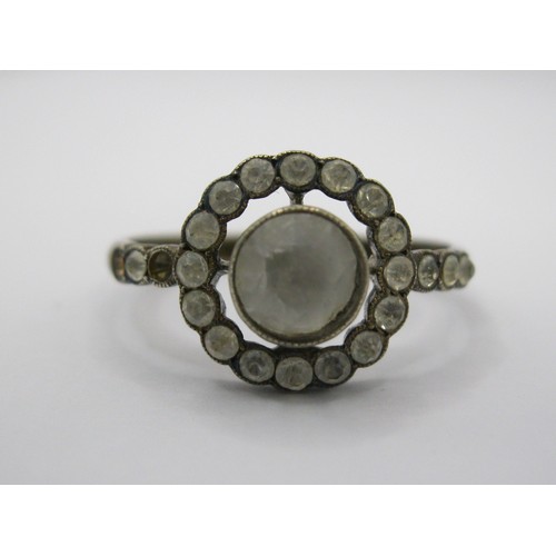 230 - A decorative daisy ring marked as 9 carat with centre clear stone surrounded by a ring of the same w... 