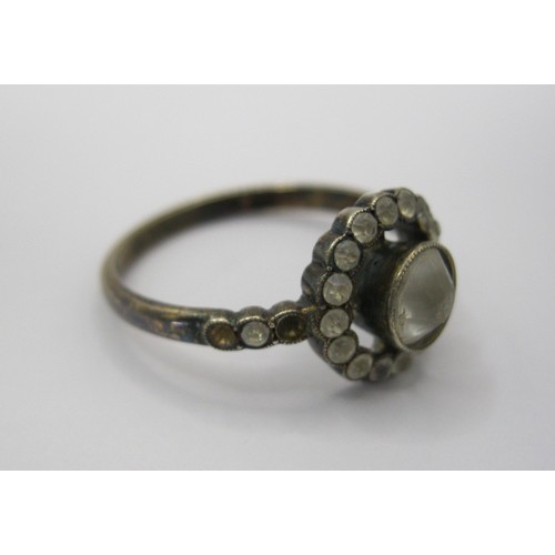 230 - A decorative daisy ring marked as 9 carat with centre clear stone surrounded by a ring of the same w... 