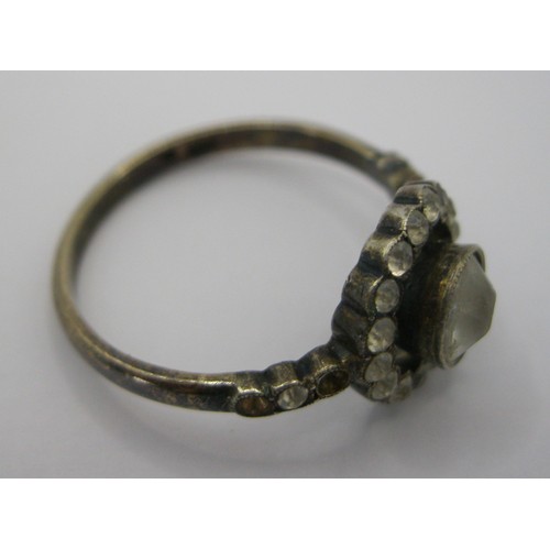 230 - A decorative daisy ring marked as 9 carat with centre clear stone surrounded by a ring of the same w... 