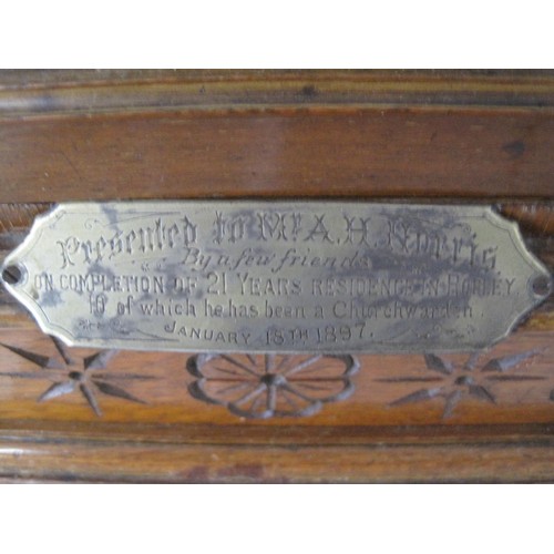 1 - An antique clock in an ornate, hand carved wooden case with silver presentation plaque to front date... 