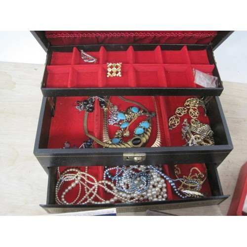 110 - A large assortment of costume jewellery contained in a large jewellery box, and three smaller jewell... 