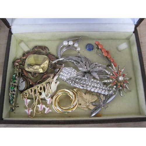 110 - A large assortment of costume jewellery contained in a large jewellery box, and three smaller jewell... 