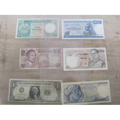 56 - A selection of UK and Foreign Banknotes, including Peru Botswana, Suriname, Madagascar etc.