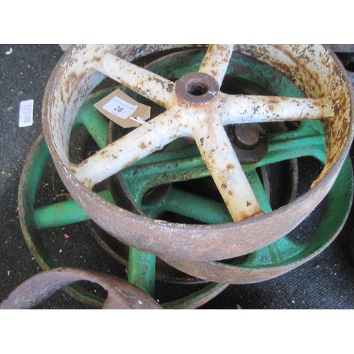 26 - H4858/80  Four assorted cast iron wheels, the biggest is 30cms diameter.