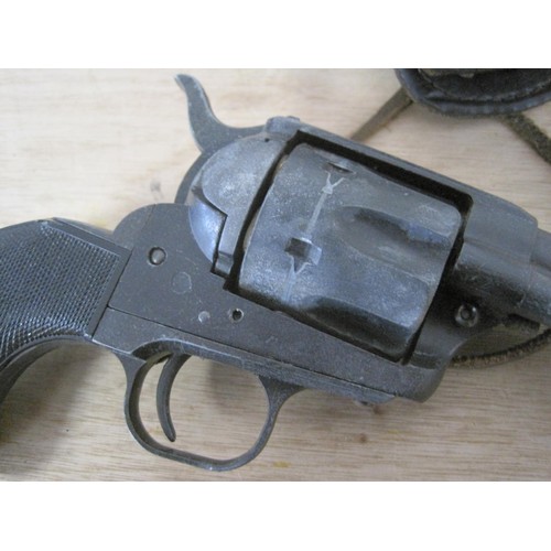 23 - A reproduction Single Action Colt Army revolver in a tooled leather western holster rig, in good sol... 