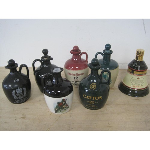 47 - A collection of stoneware whiskey jugs including commemoratives