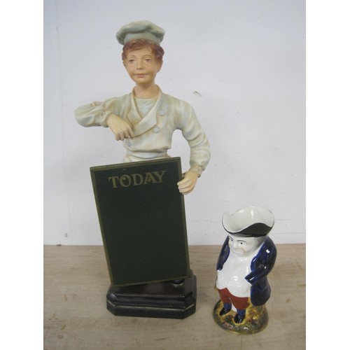 58 - A chalkware figure of a chef holding a menu board and an antique Toby jug