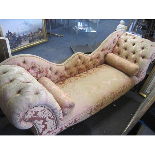 27 - A Victorian or Edwardian style drop back sofa with rolled arms and studding, on mahogany legs with b... 