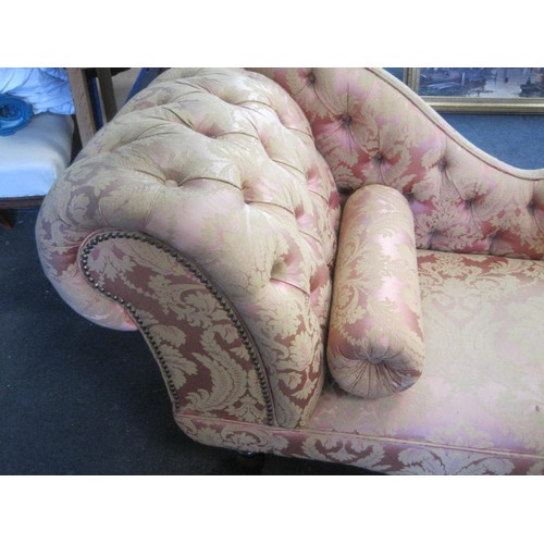 27 - A Victorian or Edwardian style drop back sofa with rolled arms and studding, on mahogany legs with b... 