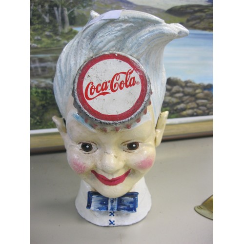 122 - A cast iron moneybox in the form of a boy, branded for Coca Cola, approx 8