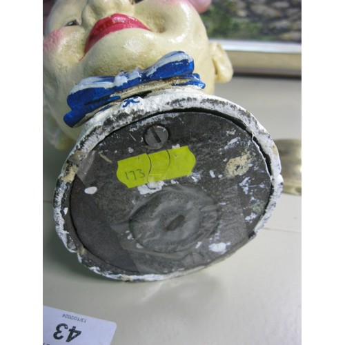 122 - A cast iron moneybox in the form of a boy, branded for Coca Cola, approx 8