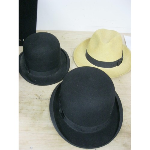 116 - A pair of bowler hats in good order, one size 56, the other 57, plus a Panama hat in size 57