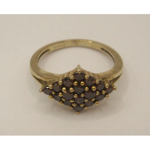 172 - A 9 carat gold ring with a lozenge-shape setting of sixteen small red stones, ring size J, gross wei... 