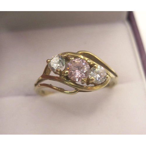 173 - 9 carat gold cubic zirconia ring, one pink stone and two white stones in a pretty crossover setting,... 