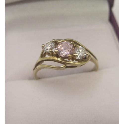 173 - 9 carat gold cubic zirconia ring, one pink stone and two white stones in a pretty crossover setting,... 