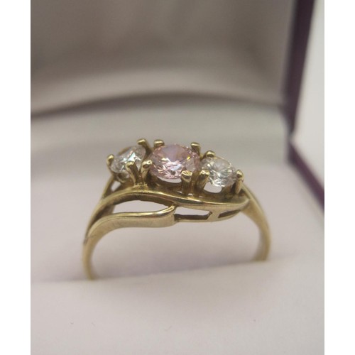 173 - 9 carat gold cubic zirconia ring, one pink stone and two white stones in a pretty crossover setting,... 