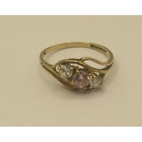 173 - 9 carat gold cubic zirconia ring, one pink stone and two white stones in a pretty crossover setting,... 