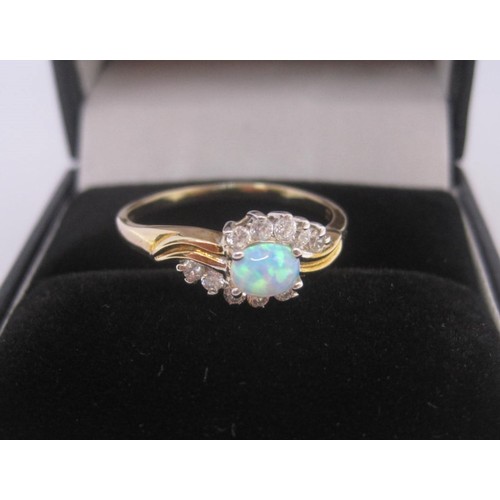 176 - 9 carat gold ring set with an opal (estimated 4.5mm x 3mm) between ten cubic zirconia stones, ring s... 