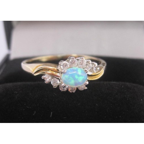 176 - 9 carat gold ring set with an opal (estimated 4.5mm x 3mm) between ten cubic zirconia stones, ring s... 