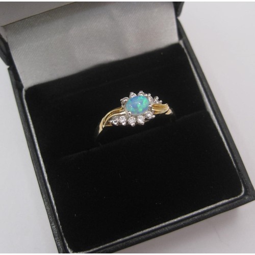 176 - 9 carat gold ring set with an opal (estimated 4.5mm x 3mm) between ten cubic zirconia stones, ring s... 