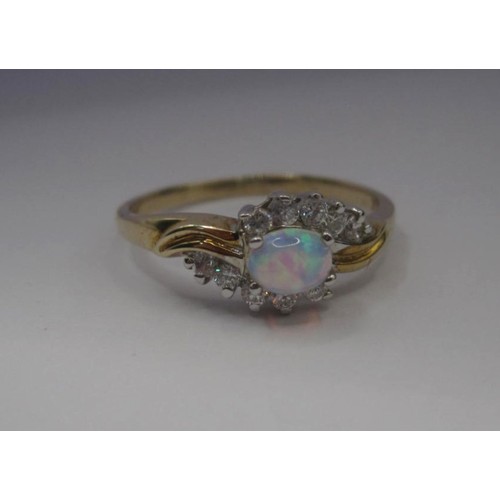 176 - 9 carat gold ring set with an opal (estimated 4.5mm x 3mm) between ten cubic zirconia stones, ring s... 