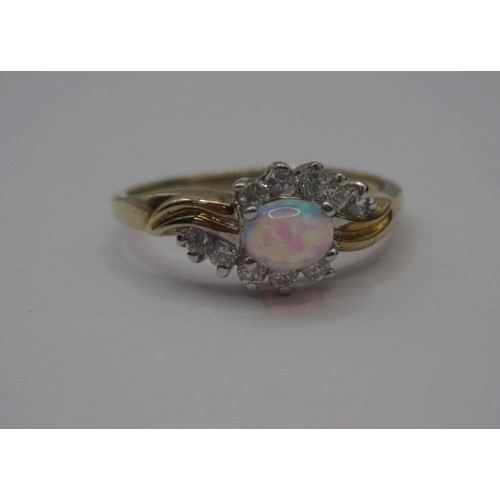 176 - 9 carat gold ring set with an opal (estimated 4.5mm x 3mm) between ten cubic zirconia stones, ring s... 