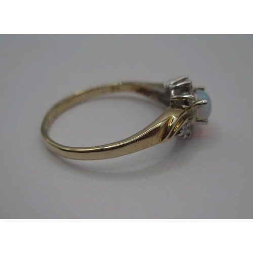 176 - 9 carat gold ring set with an opal (estimated 4.5mm x 3mm) between ten cubic zirconia stones, ring s... 