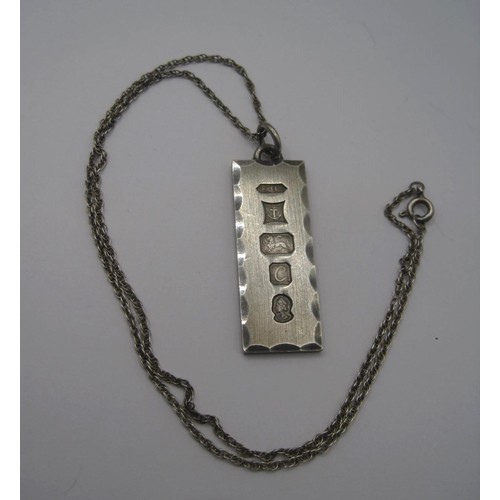 181 - A silver ingot pendant with large hallmarks for Birmingham, 1977, on 925 chain, combined 17.9g