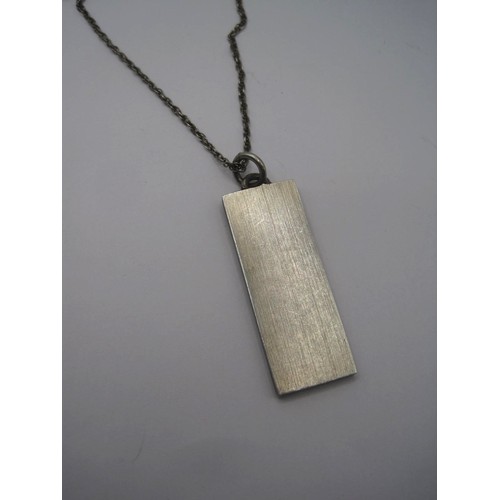 181 - A silver ingot pendant with large hallmarks for Birmingham, 1977, on 925 chain, combined 17.9g