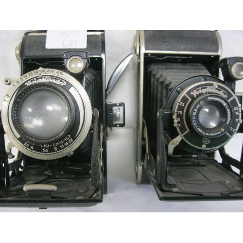 189 - A pair of antique Voigtlander bellows cameras comprising: a Bessa with Voigtar 1:7.7 F=10.5cm lens a... 